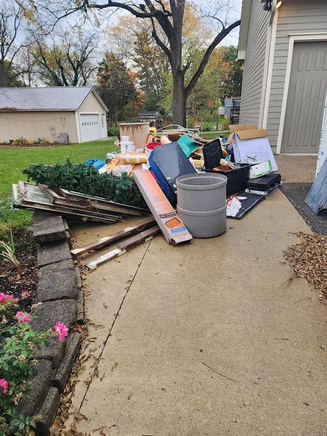 Dumpster being loaded with debris for Estate Cleanout Dumpster Rental in Creswell